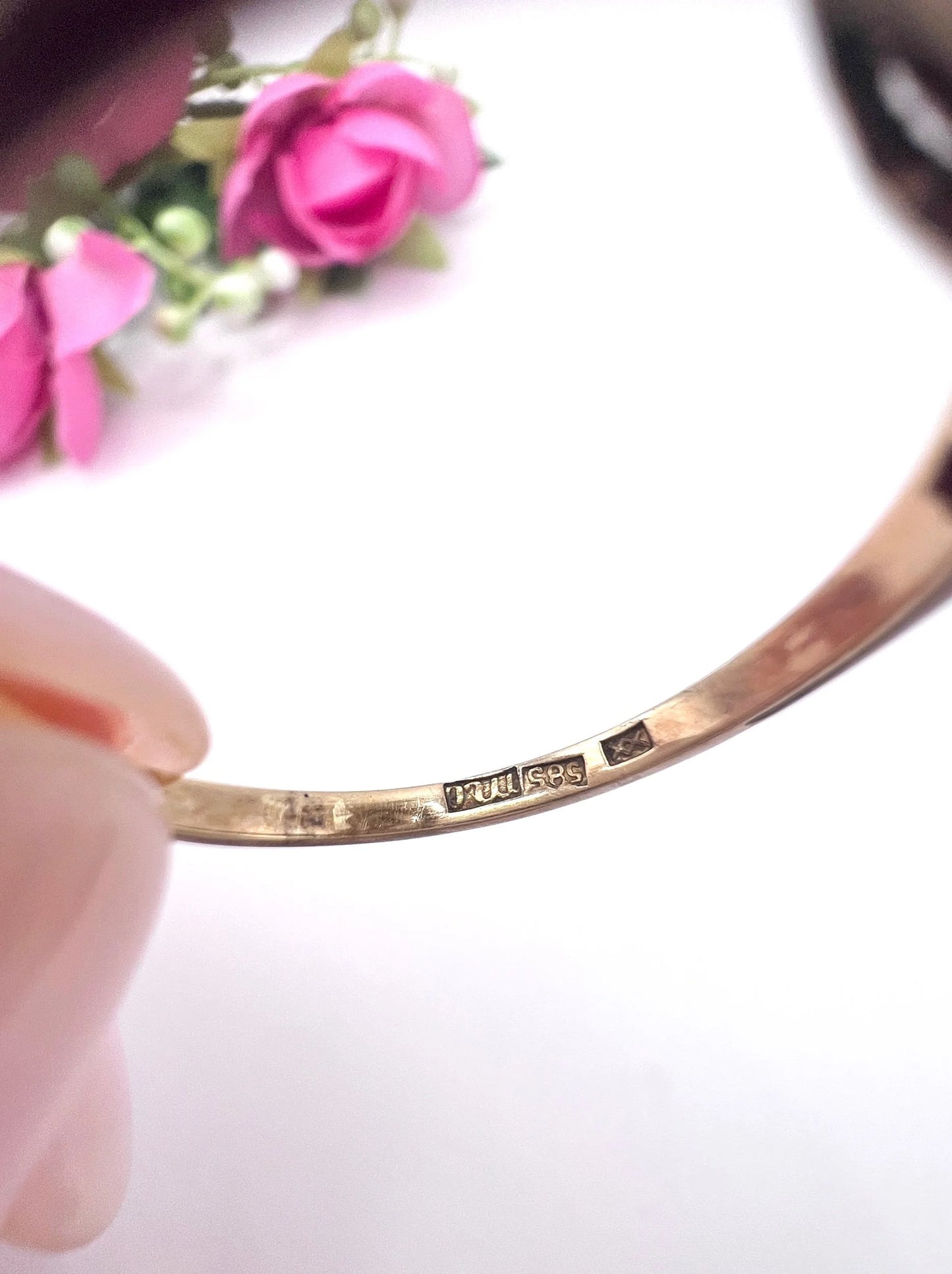 Close-up of a 585 stamp inside a yellow gold ring shank