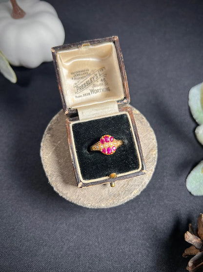 A yellow gold ruby and pearl cluster ring, in a ring box