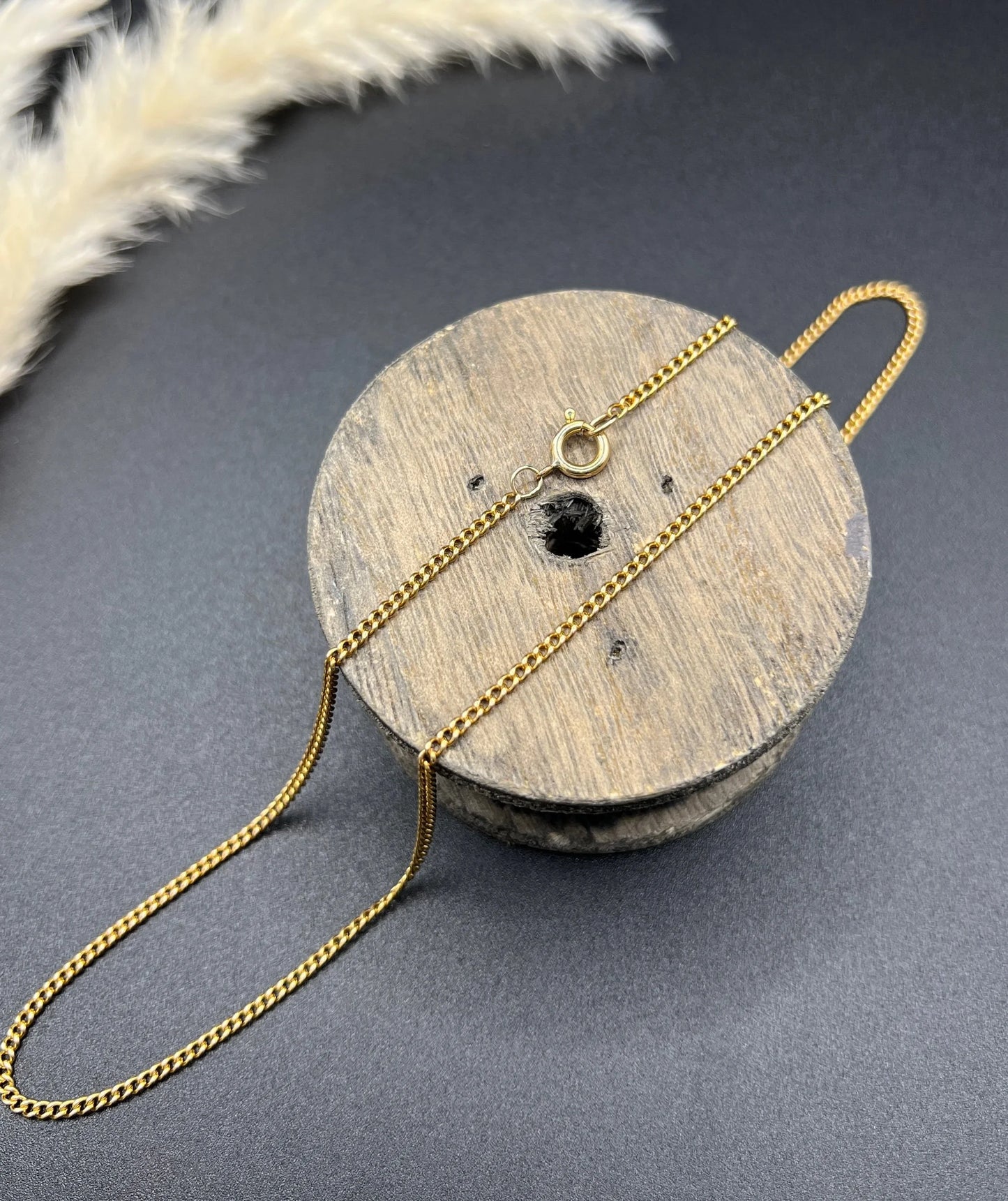A fine curb link chain necklace in yellow gold