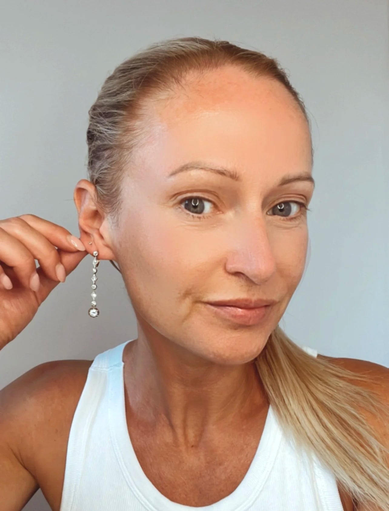 A pair of diamond drop earrings in yellow gold and platinum, modelled in an ear