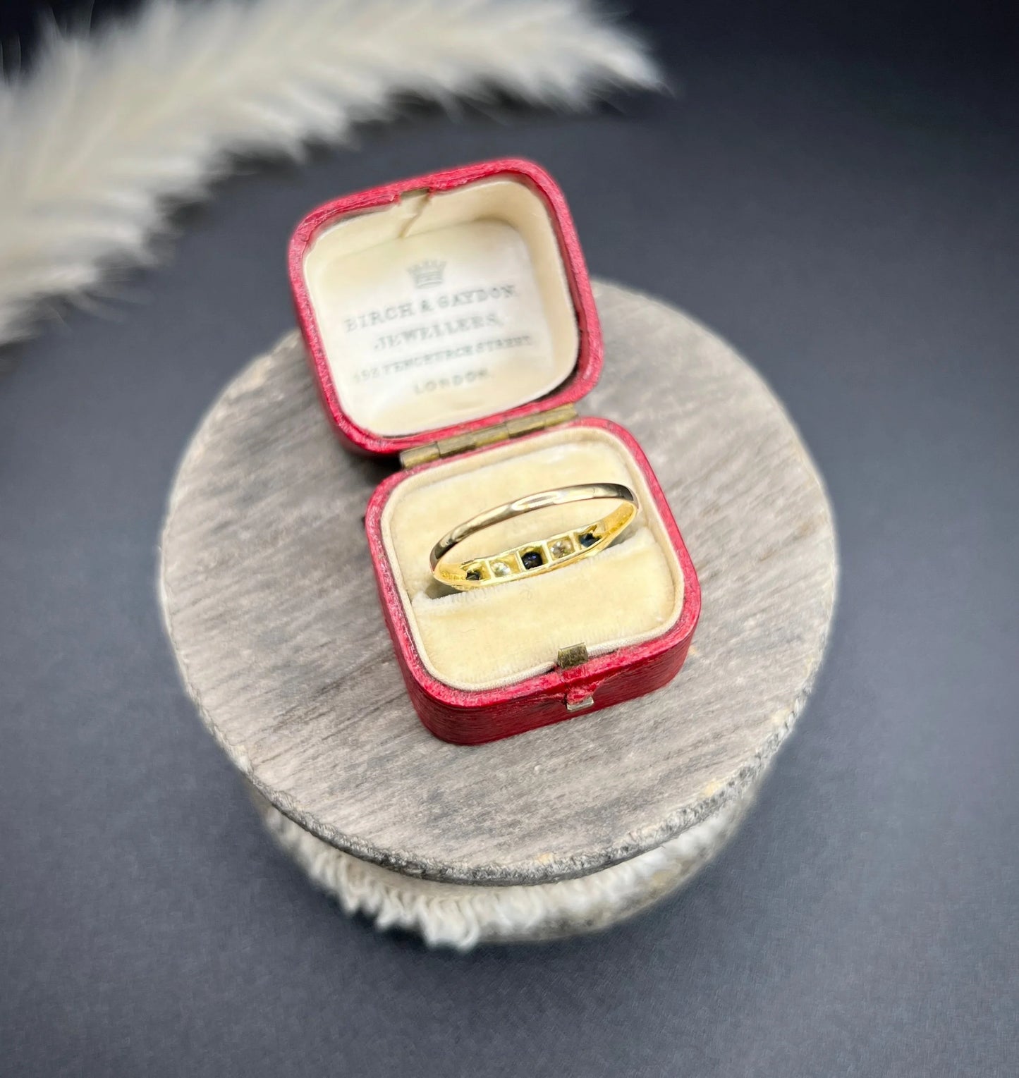 A yellow gold five stone sapphire and diamond carved half hoop ring