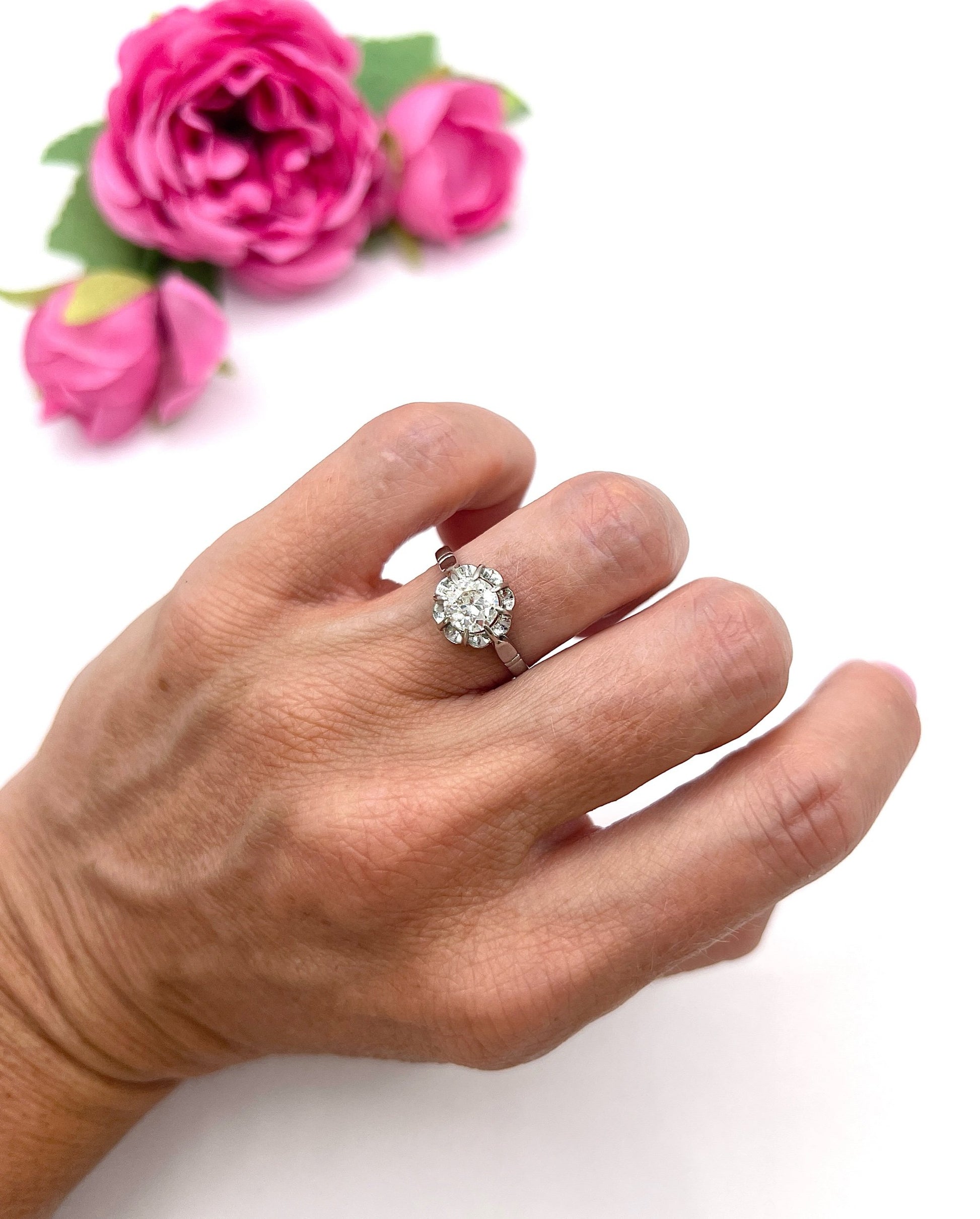 A solitaire diamond ring in platinum, modelled on a hand