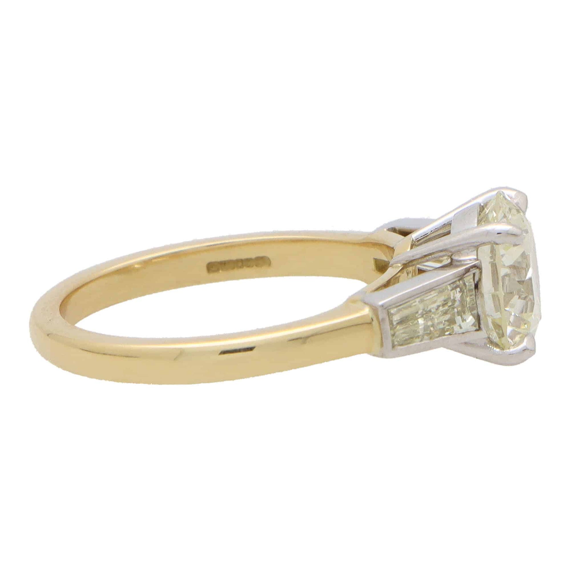 Vintage 2.56 carat diamond three stone ring in yellow gold and platinum.