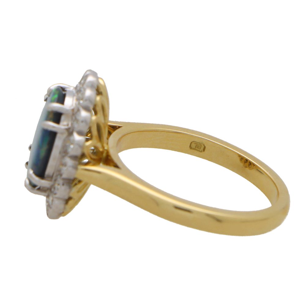 Black opal and diamond cluster ring in gold and platinum.