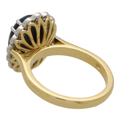 Black opal and diamond cluster ring in gold and platinum.