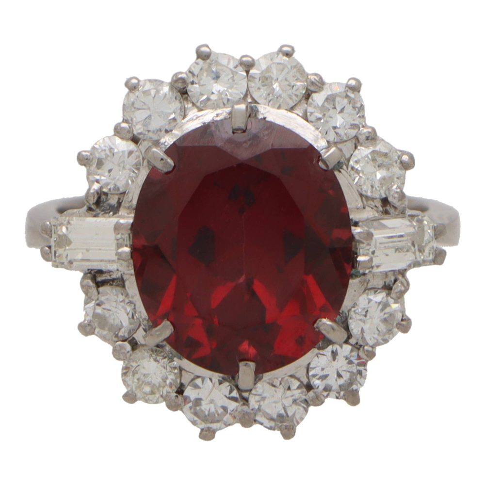 Garnet and diamond halo ring set in platinum.