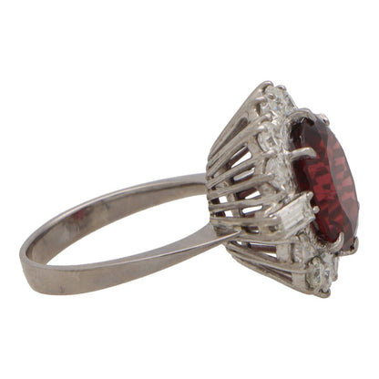 Garnet and diamond halo ring set in platinum.