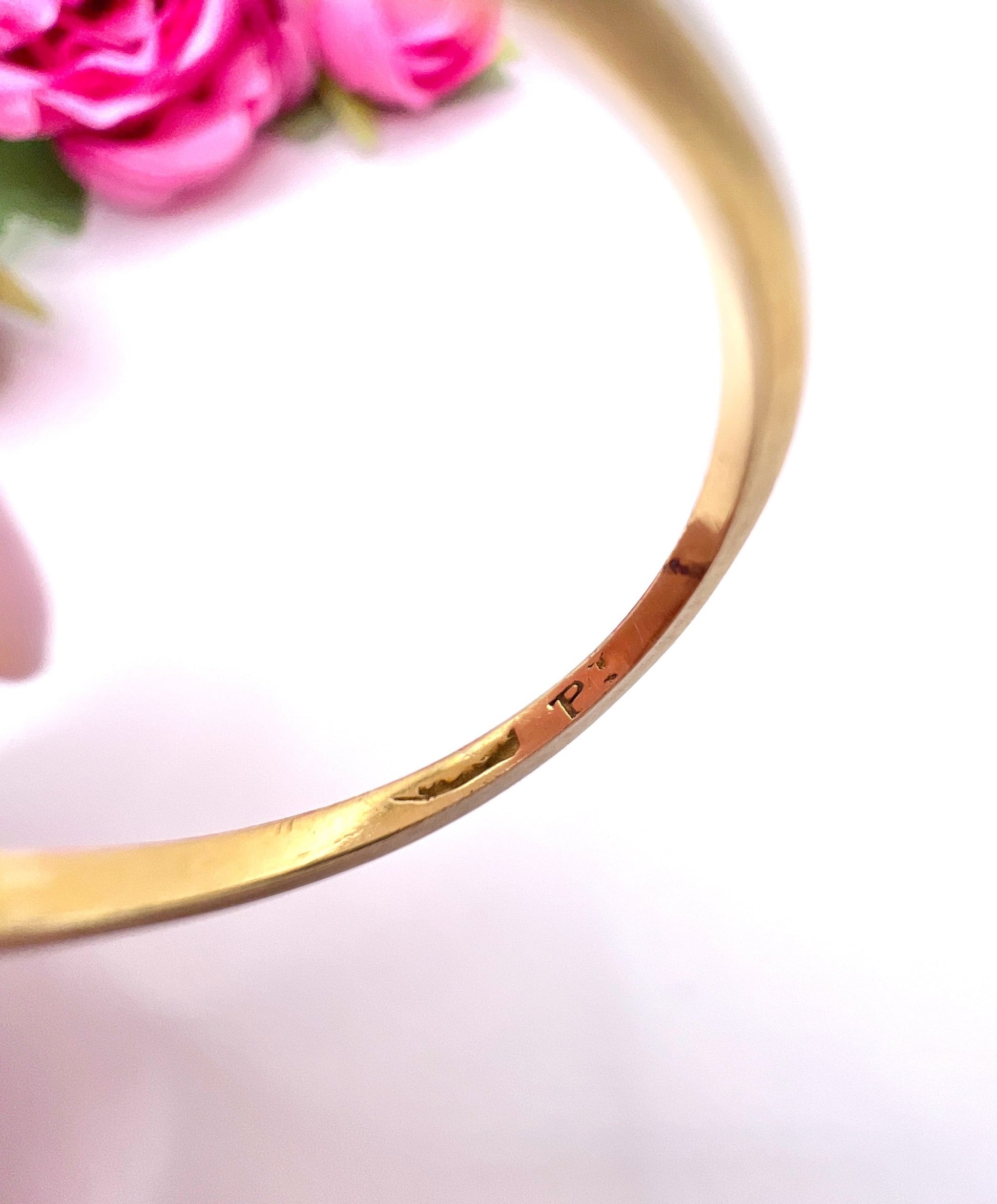 Close-up of stamps inside a yellow gold ring shank
