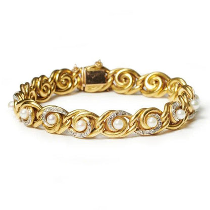 Antique French Art Nouveau Gold Swirl Bracelet with Diamonds and Pearls, 18ct yellow gold bracelet comprised of swirling knot links with white pearls and rose-cut diamonds. Circa 1900