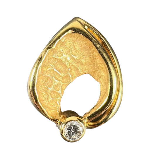 A yellow gold leaf shaped pendant with a diamond, on a white background