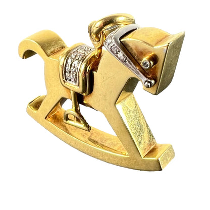 A yellow and white gold rockinghorse pendant with diamonds, on a white background