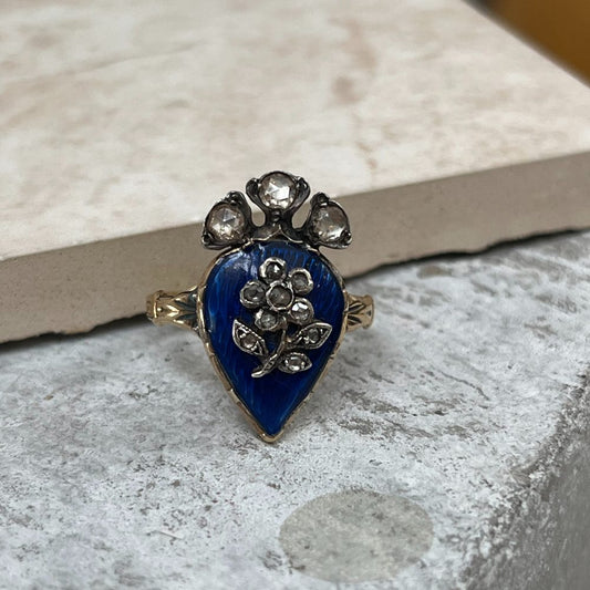 Antique late Victorian ring with blue enamel and diamond flower design.