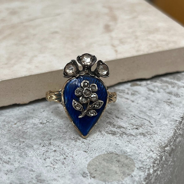 Antique late Victorian ring with blue enamel and diamond flower design.