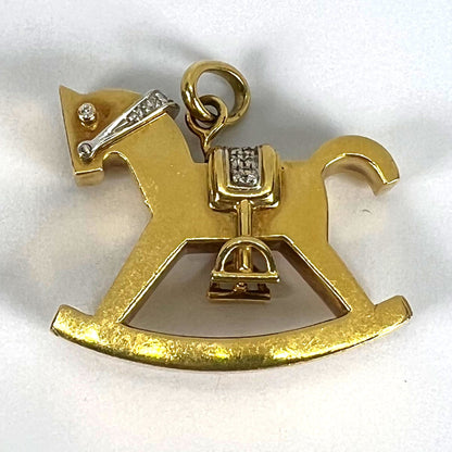 A yellow and white gold rockinghorse pendant with diamonds, on a white background