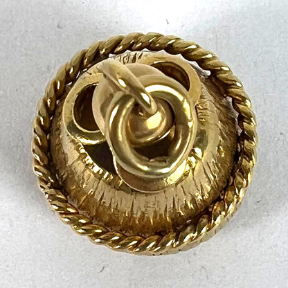 A yellow gold pendant, on a white background
