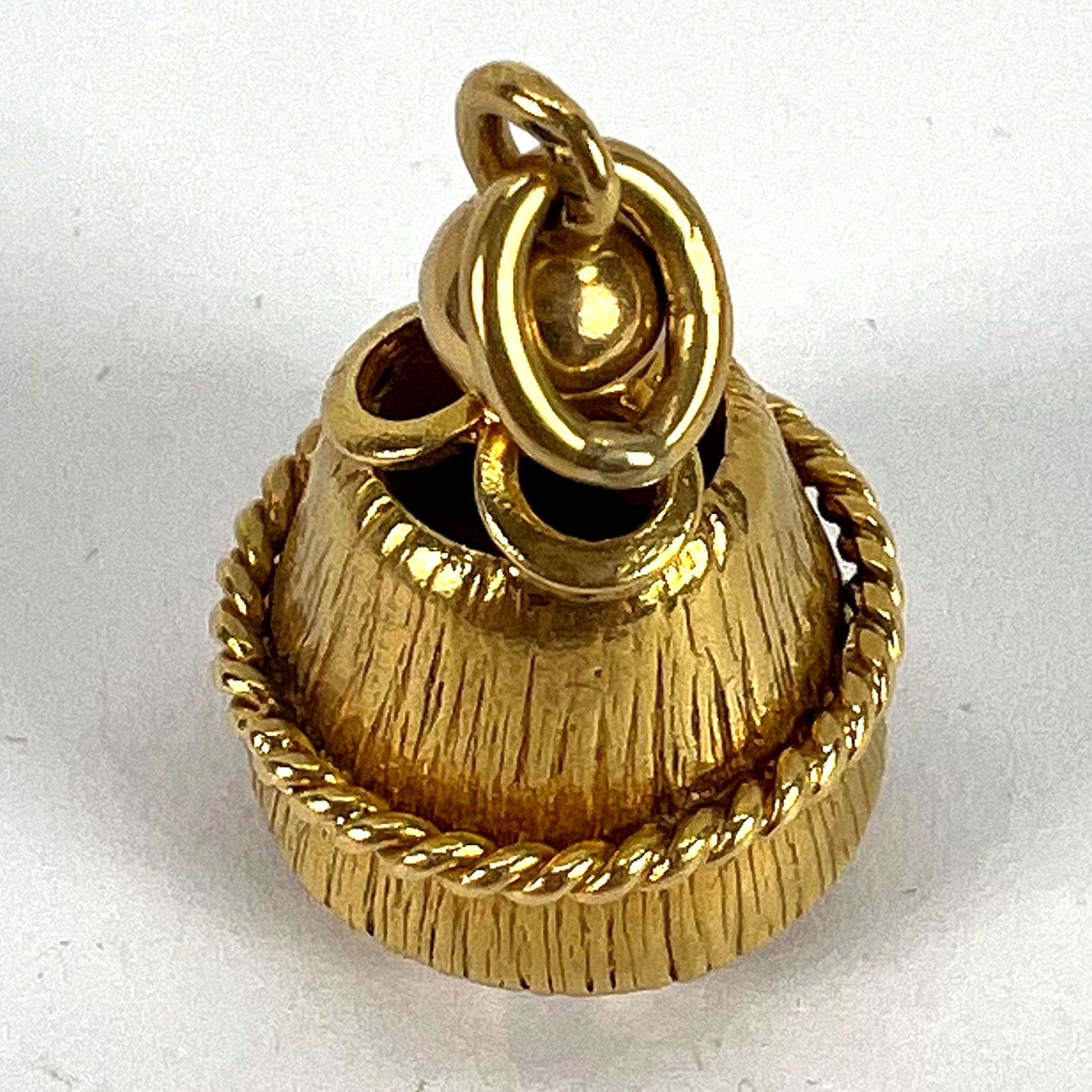 A yellow gold pendant on a white background