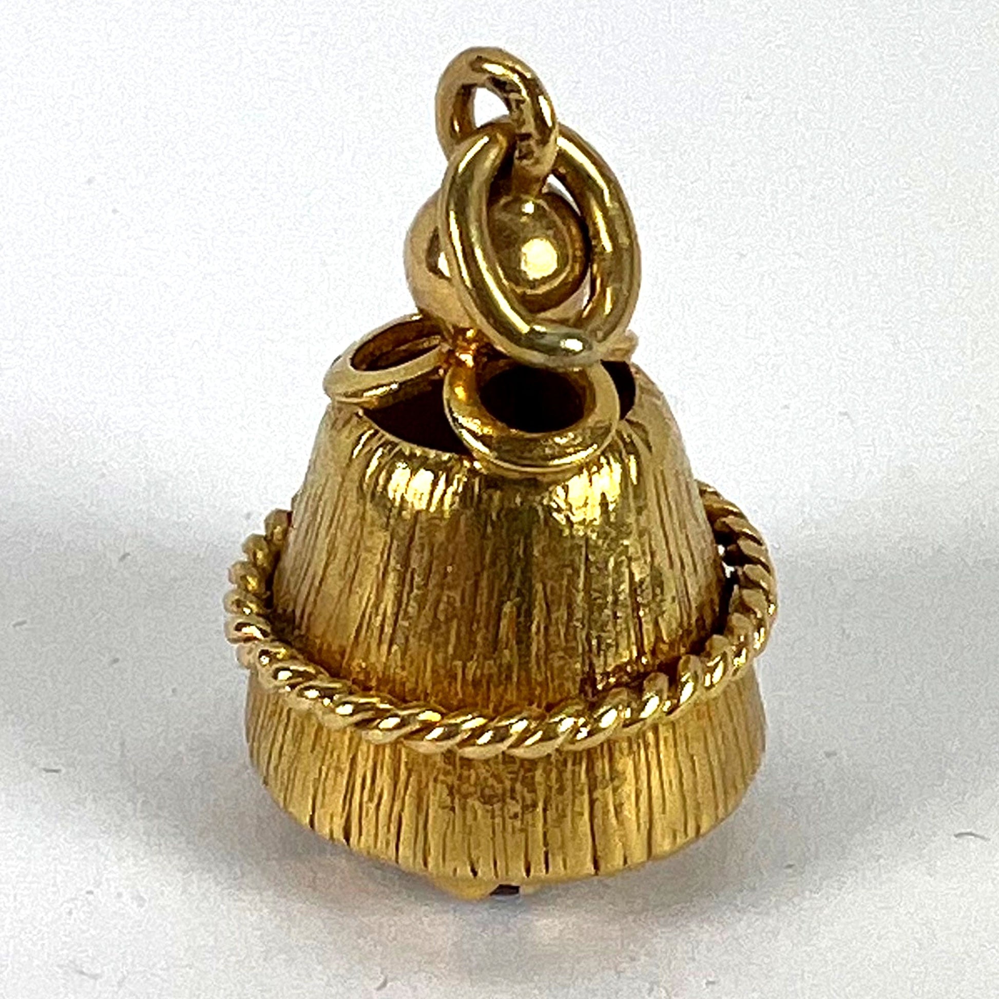 A yellow gold pendant, on a white background