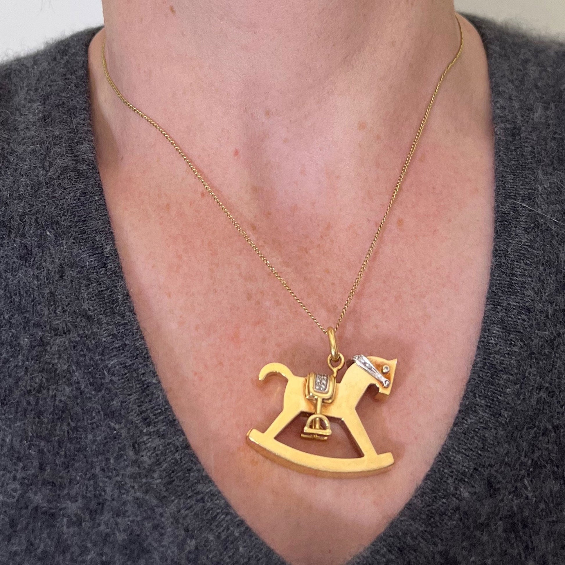 A yellow and white gold rockinghorse pendant with diamonds, modelled with a gold chain