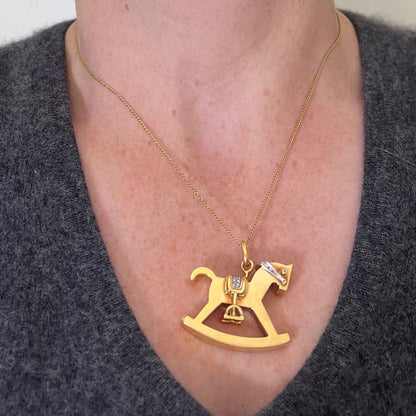 A yellow and white gold rockinghorse pendant with diamonds, modelled with a gold chain