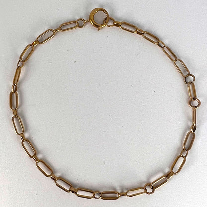 A yellow gold link bracelet with bolt ring clasp, on a white background