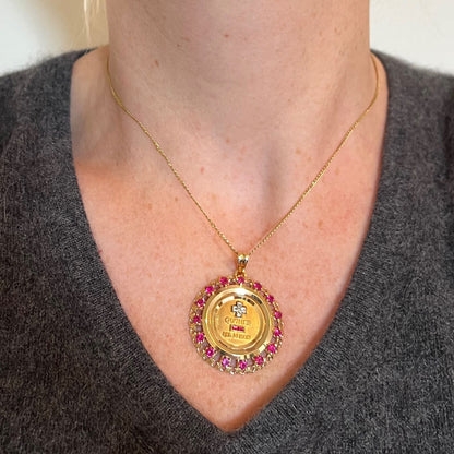A French QU'HIER QUE DEMAIN pendant with diamonds and synthetic rubies, modelled with a gold chain