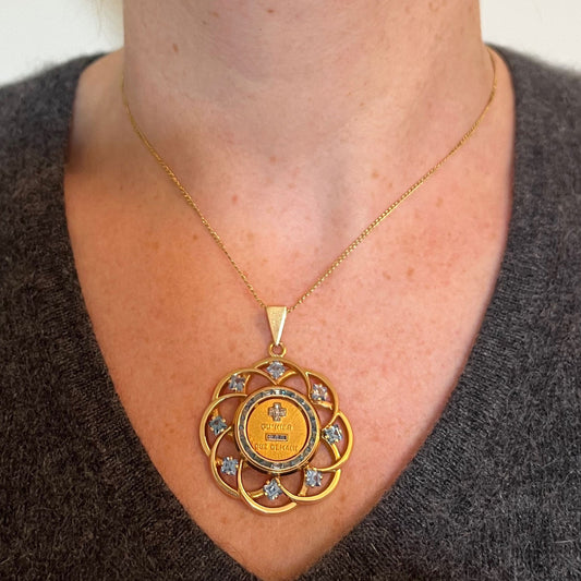 A yellow gold French QU'HIER QUE DEMAIN pendant with blue stones and diamonds, modelled on a gold chain