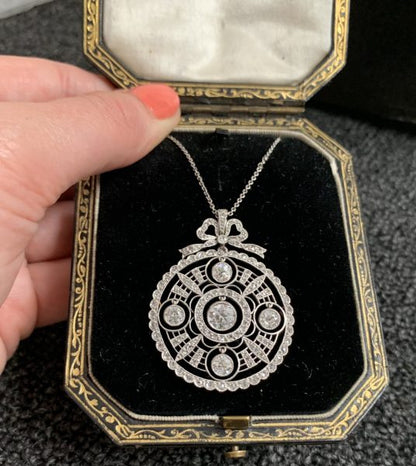 Antique Edwardian platinum diamond old cut pendant round bow articulated fine open work