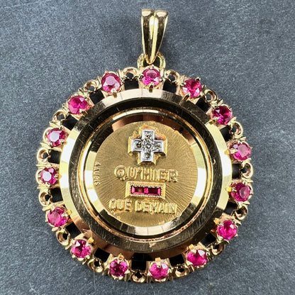 A French QU'HIER QUE DEMAIN pendant with diamonds and synthetic rubies, on a grey background