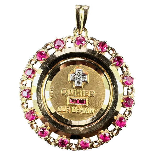 A French QU'HIER QUE DEMAIN pendant with diamonds and synthetic rubies, on a white background