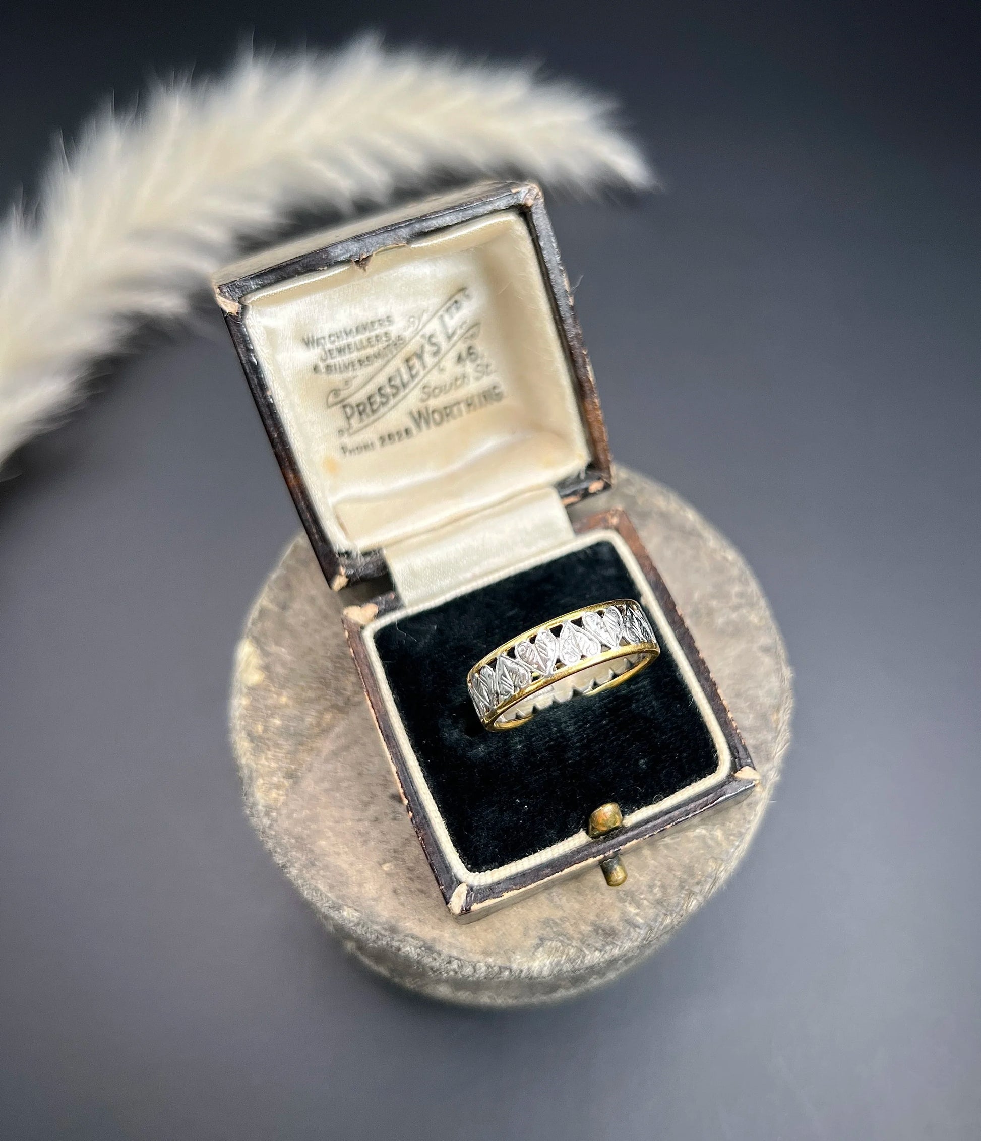 A yellow gold and platinum heart cutout band ring, in a ring box