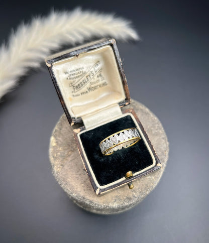 A yellow gold and platinum heart cutout band ring, in a ring box