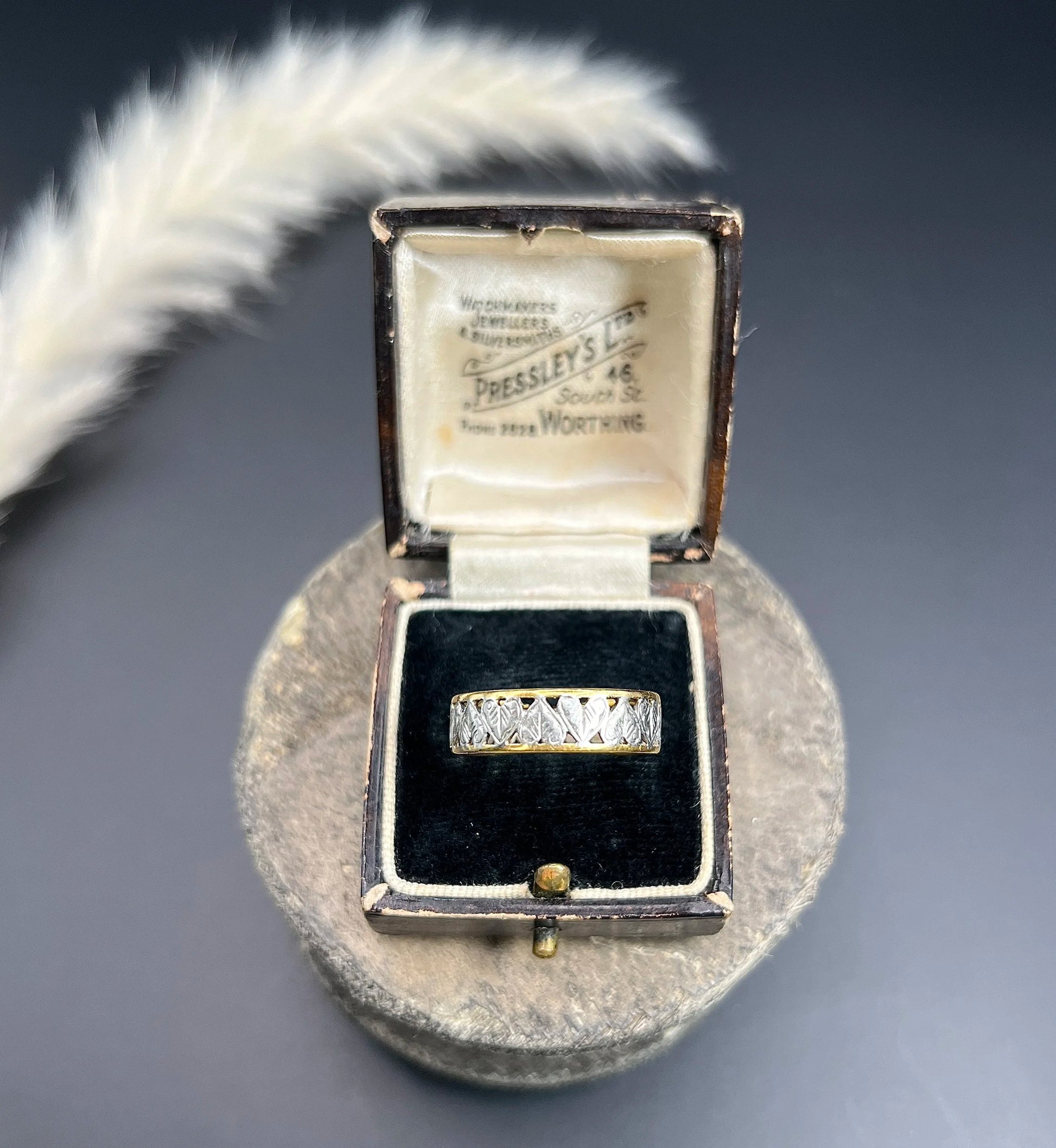 A yellow gold and platinum heart cutout band ring, in a ring box