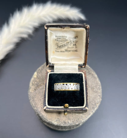 A yellow gold and platinum heart cutout band ring, in a ring box