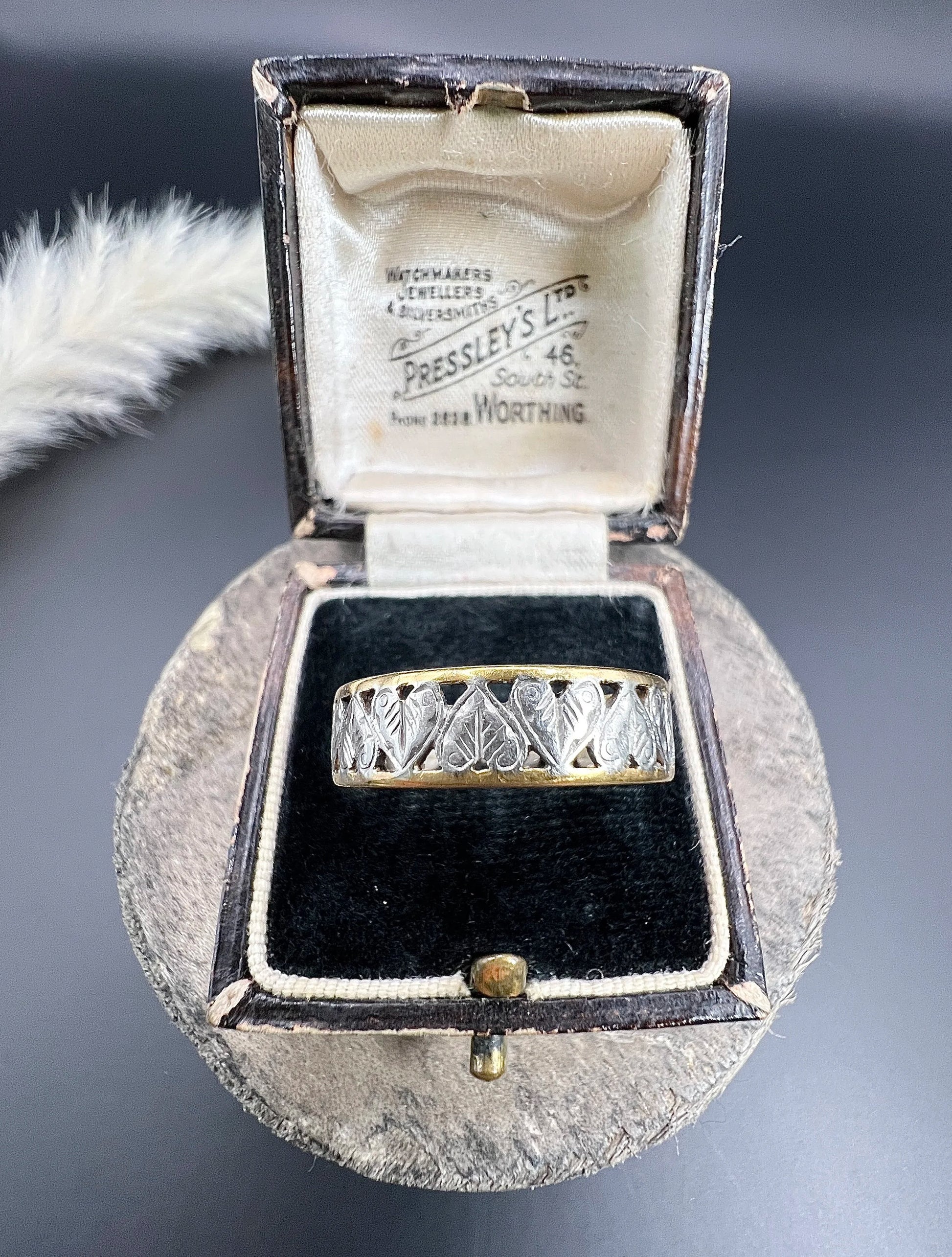 A yellow gold and platinum heart cutout band ring, in a ring box