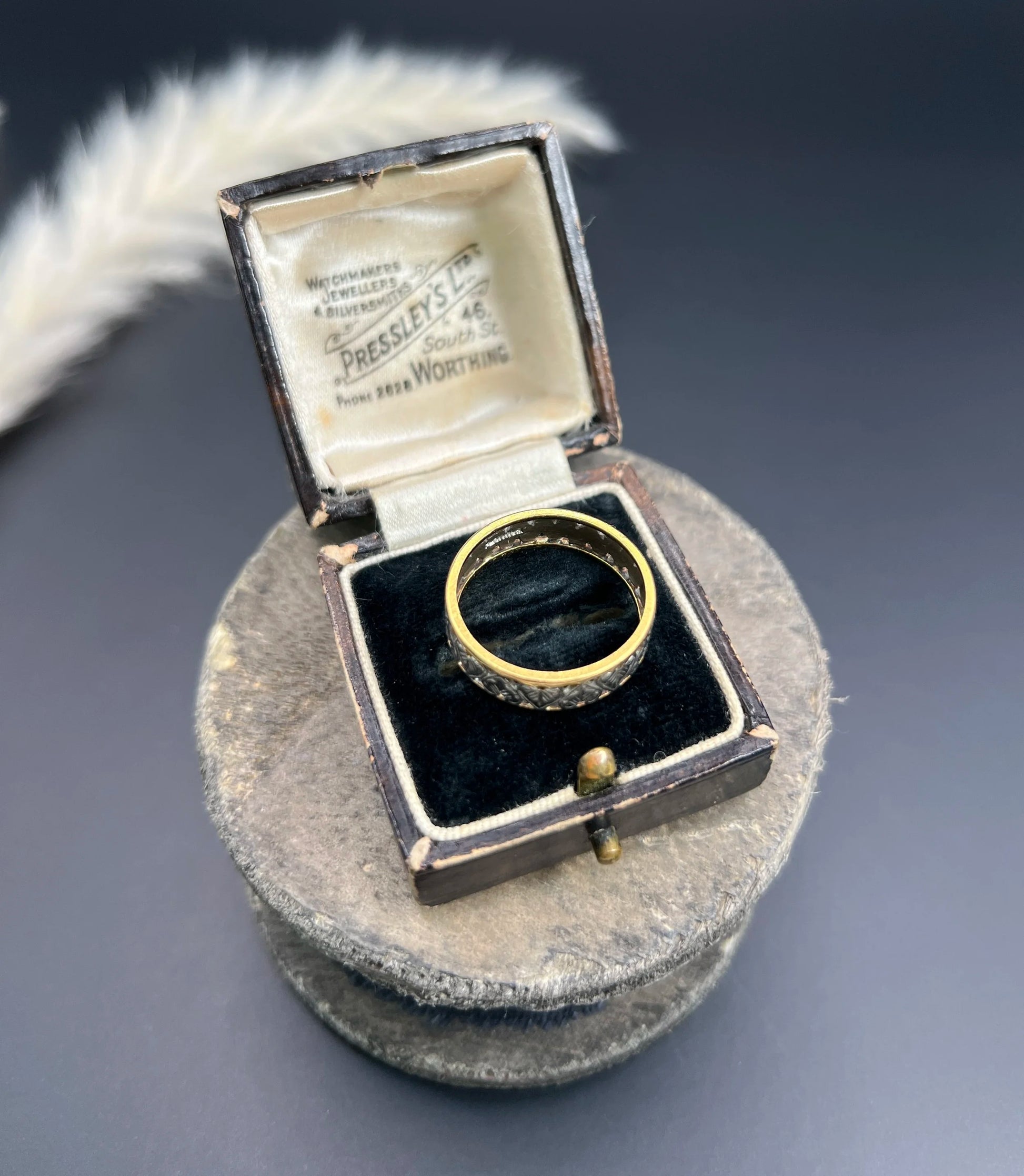 A yellow gold and platinum heart cutout band ring, in a ring box