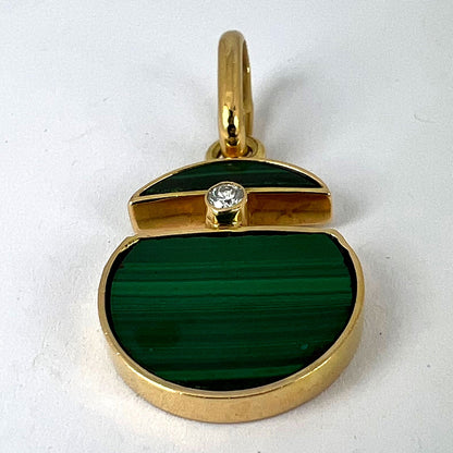 A malachite and diamond yellow gold split circle pendant, on a white background