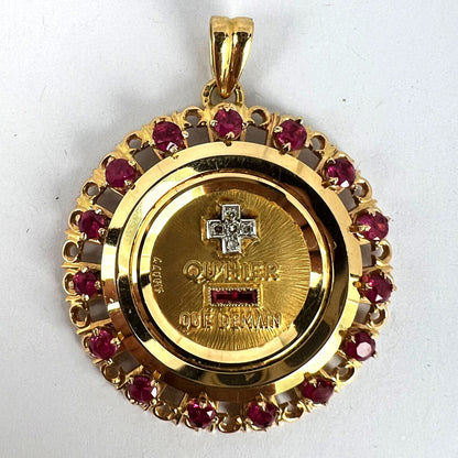 A French QU'HIER QUE DEMAIN pendant with diamonds and synthetic rubies, on a white background