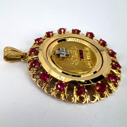 A French QU'HIER QUE DEMAIN pendant with diamonds and synthetic rubies, on a white background