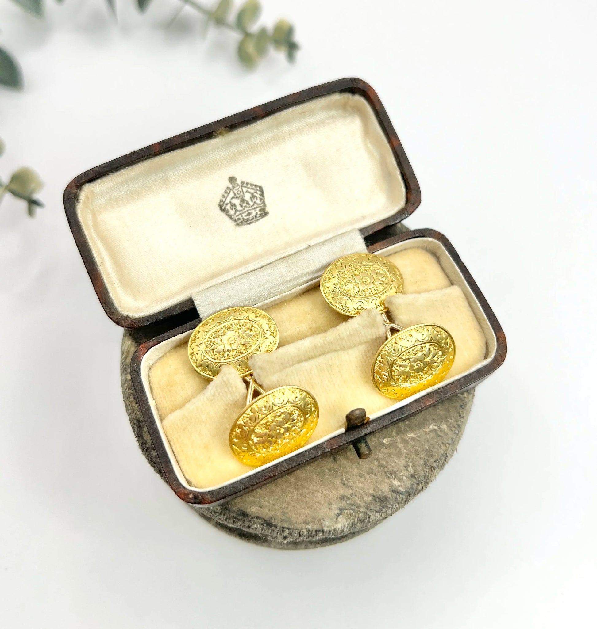 A pair of yellow gold oval engraved cufflinks, in an antique box