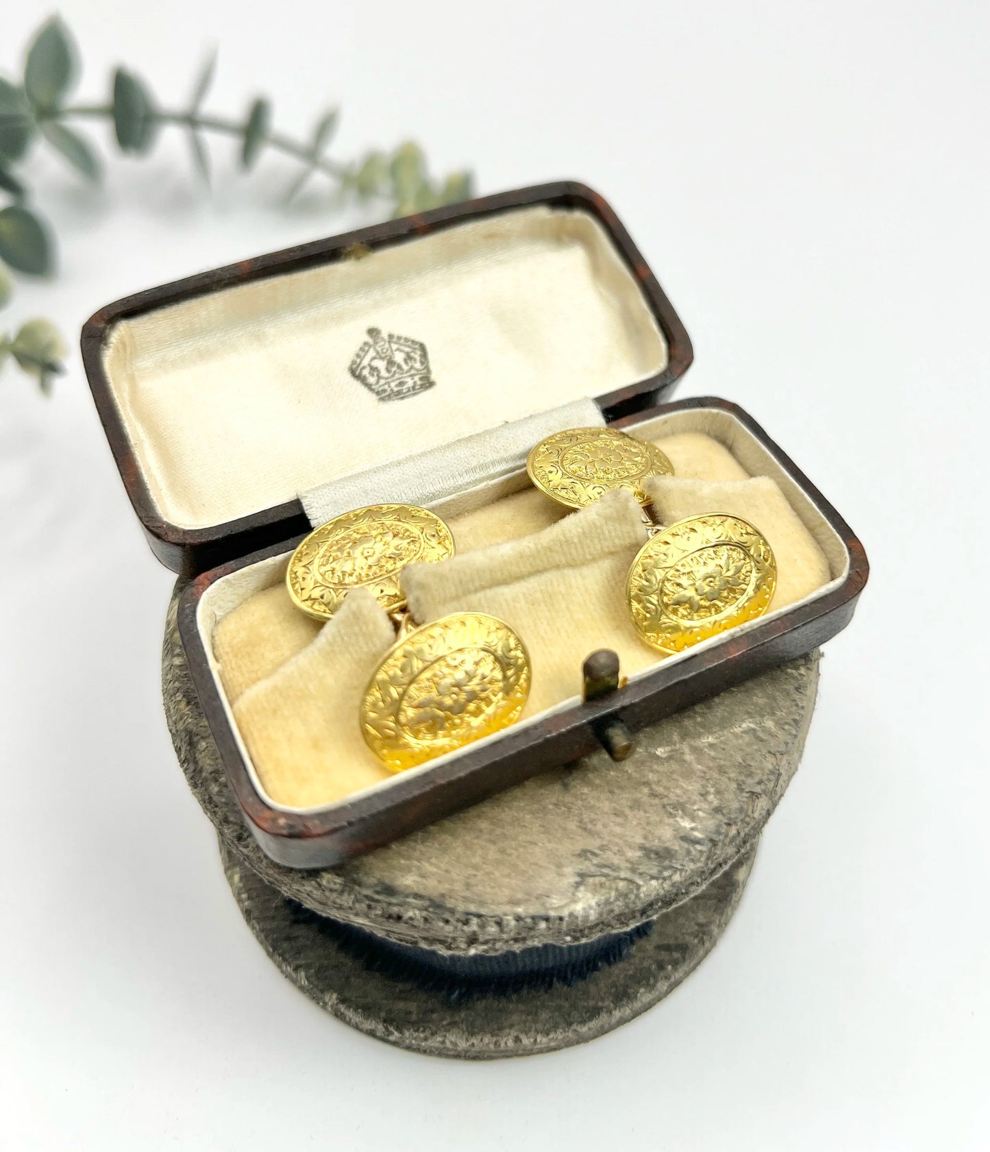 A pair of yellow gold oval engraved cufflinks, in an antique box