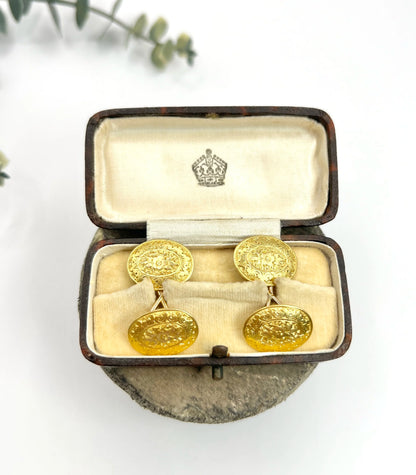 A pair of yellow gold oval engraved cufflinks, in an antique box