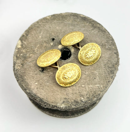 A pair of yellow gold oval engraved cufflinks