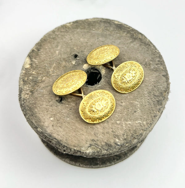 A pair of yellow gold oval engraved cufflinks
