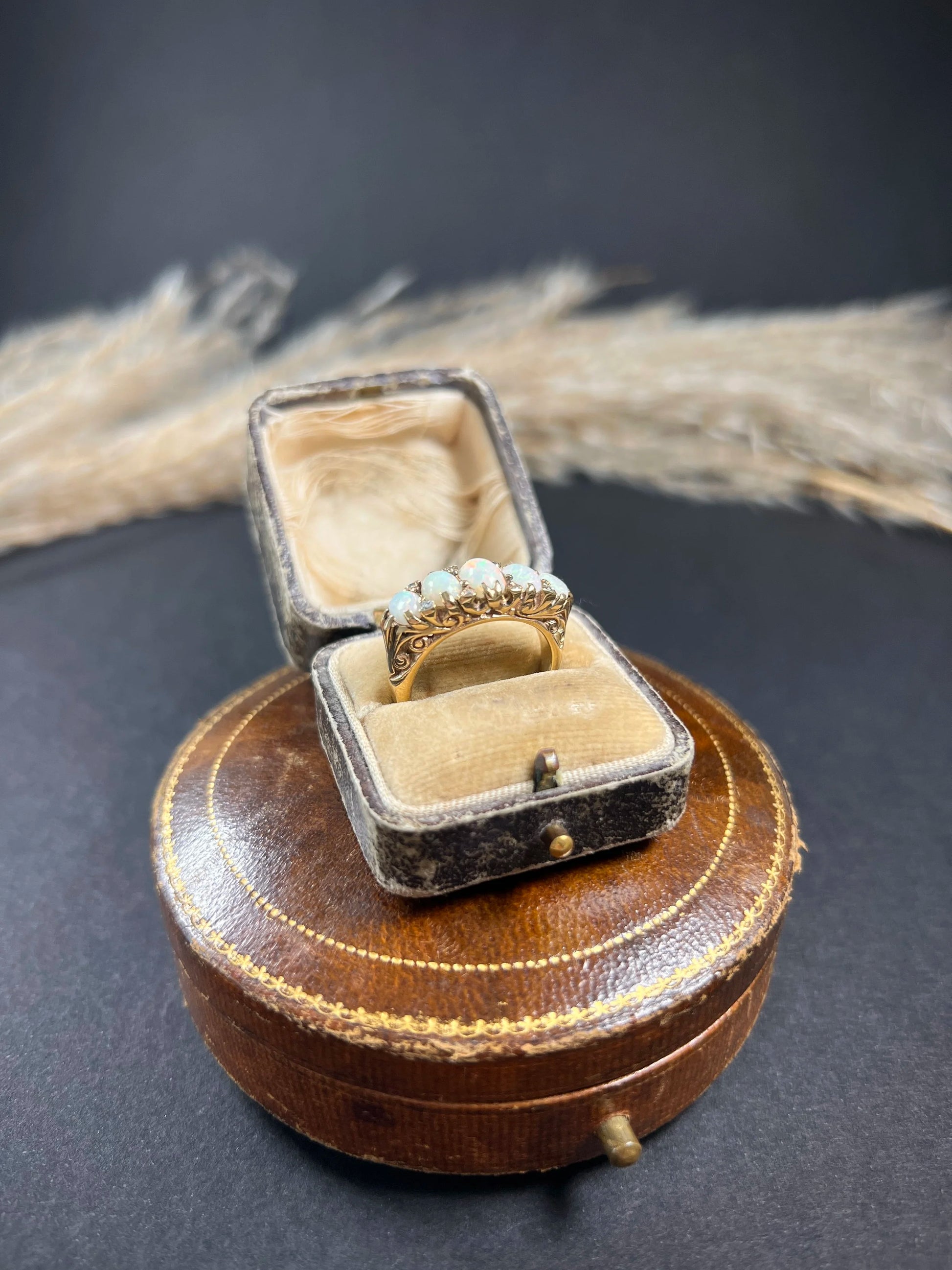 A cabochon opal and diamond carved half hoop ring in yellow gold, in a ring box
