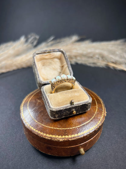 A cabochon opal and diamond carved half hoop ring in yellow gold, in a ring box