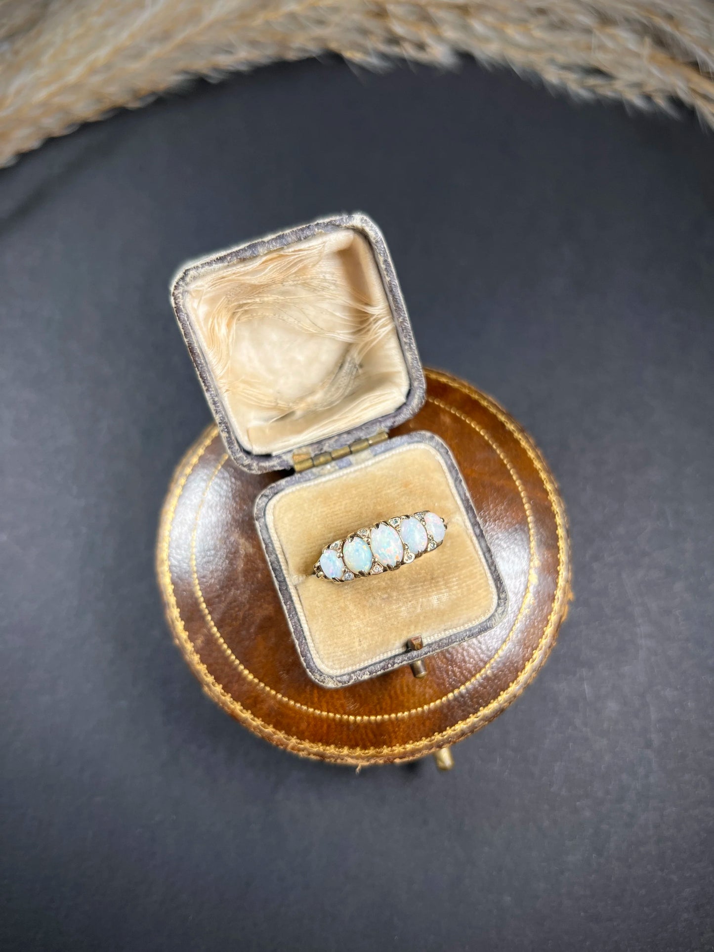 A cabochon opal and diamond carved half hoop ring in yellow gold, in a ring box