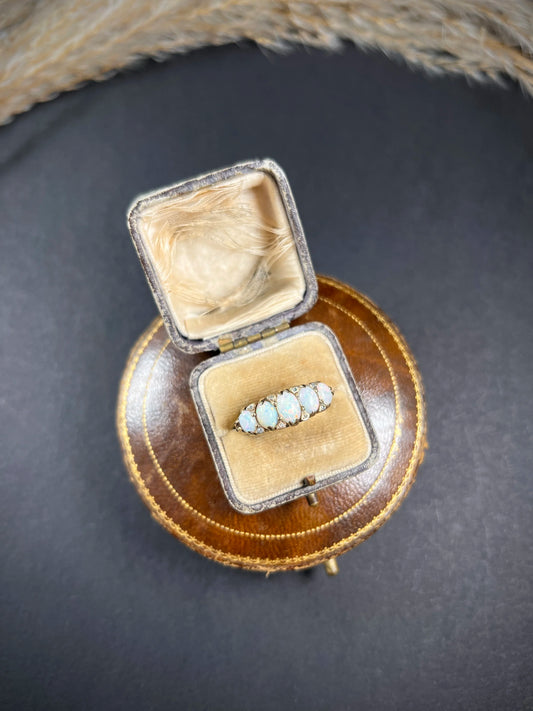 A cabochon opal and diamond carved half hoop ring in yellow gold, in a ring box