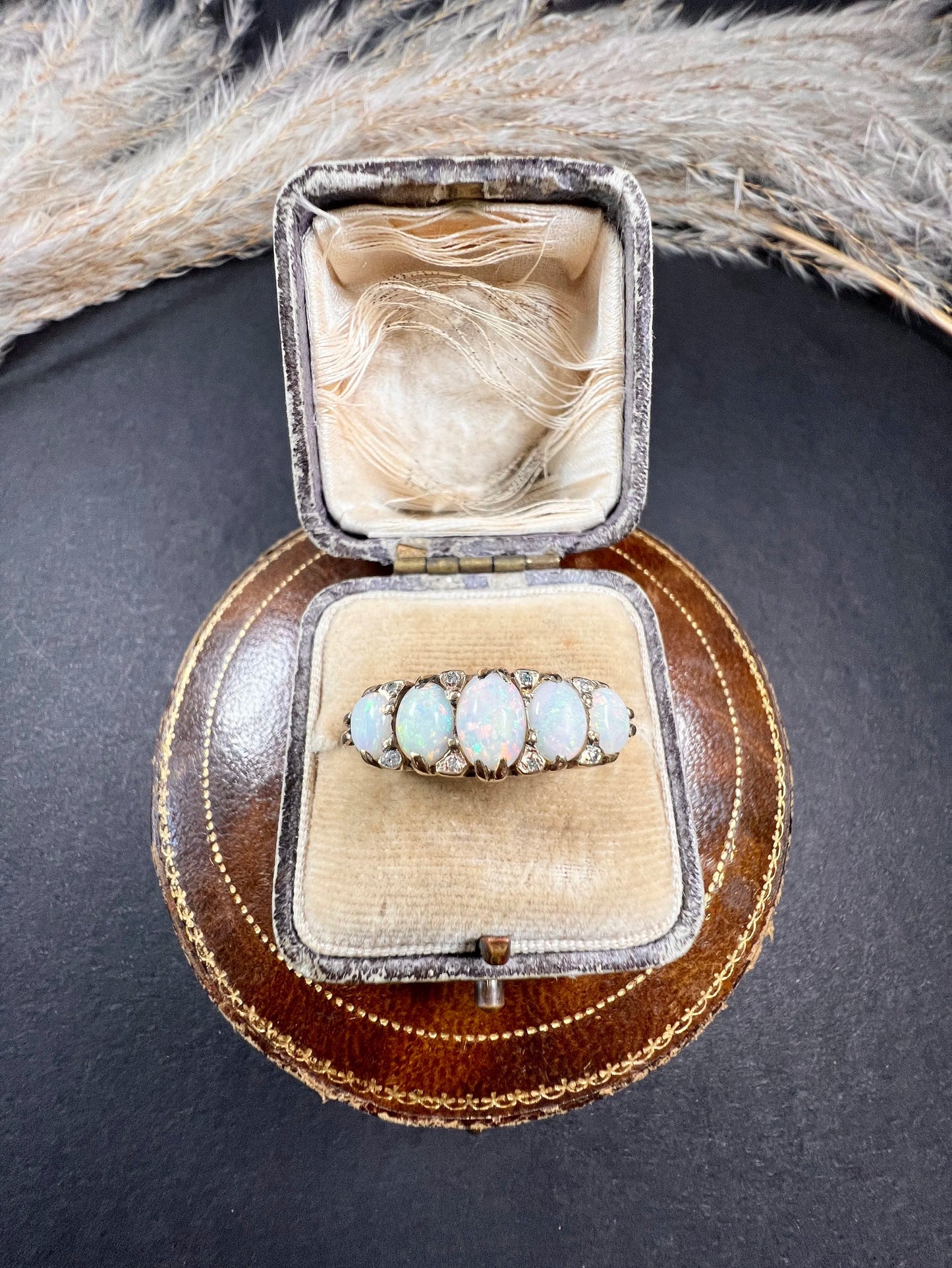A cabochon opal and diamond carved half hoop ring in yellow gold, in a ring box