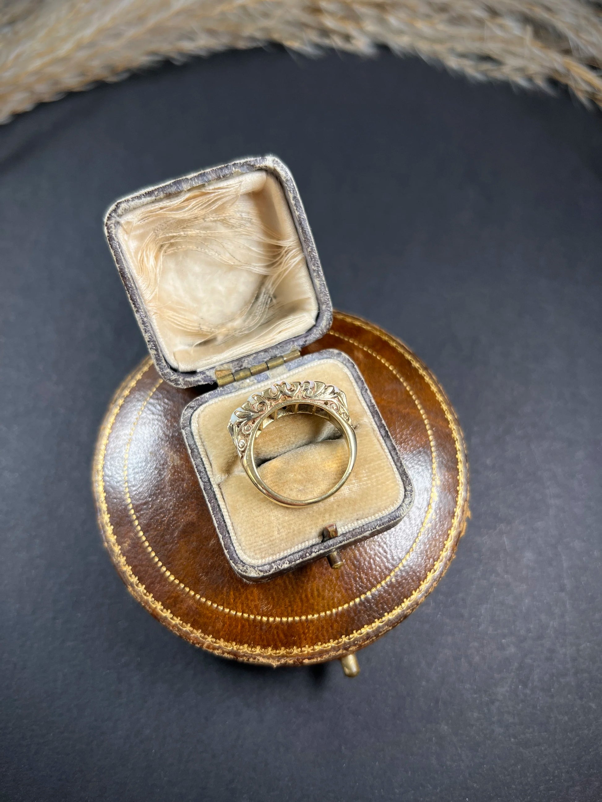 A cabochon opal and diamond carved half hoop ring in yellow gold, in a ring box