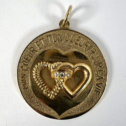 A round yellow gold love heart diamond pendant engraved MON COEUR ET TON COEUR POUR LA VIE